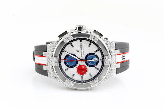 Luxury watch with a white face, red and blue accents, and a silver case on a white background.
