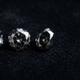 Three natural loose black diamonds in round, oval and asscher cuts on dark velvet for the complete buying guide