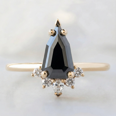 Feature-Focused: Fancy black diamond in a geometric V-setting with a round white diamond halo.
