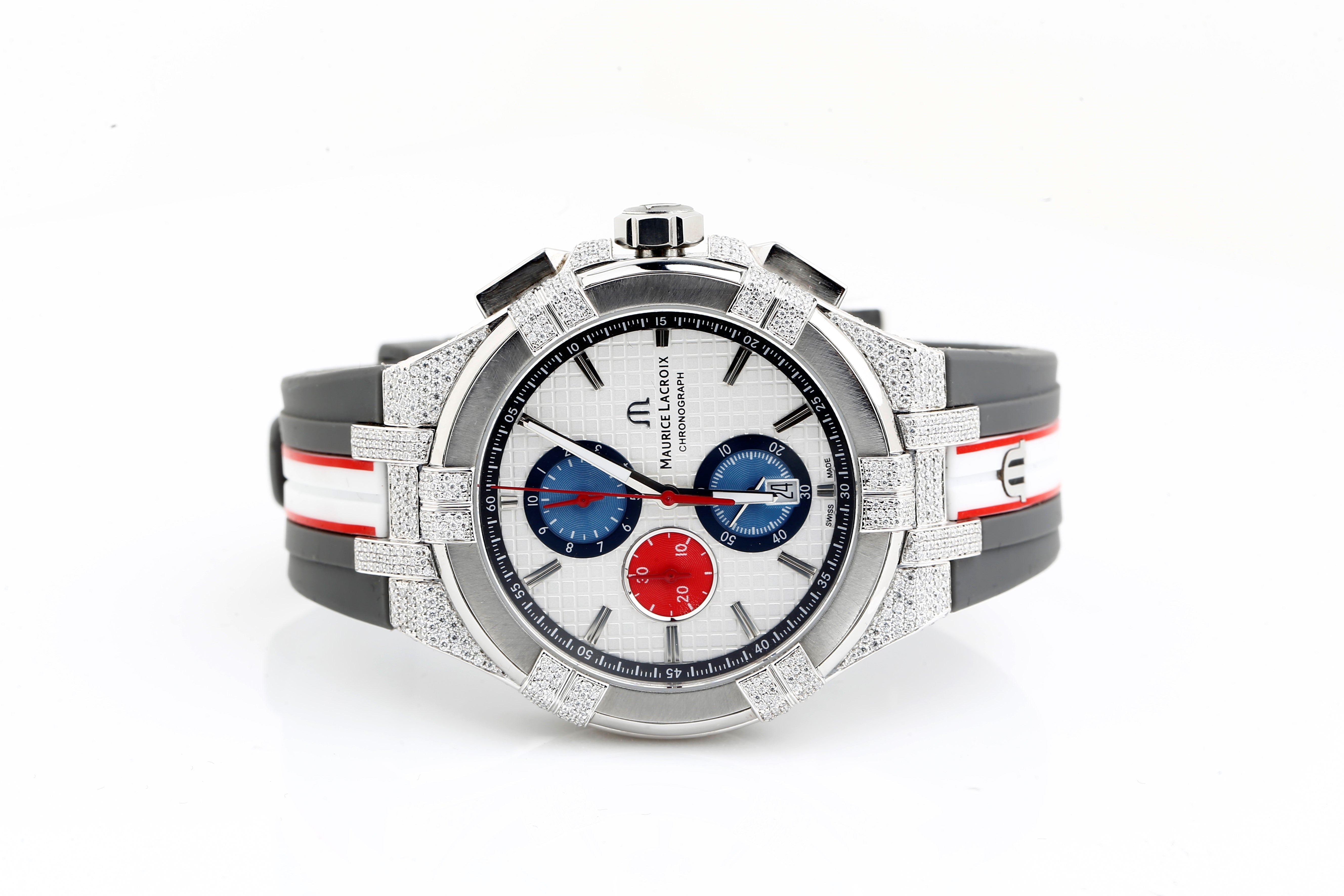 Luxury watch with a white face, red and blue accents, and a silver case on a white background.